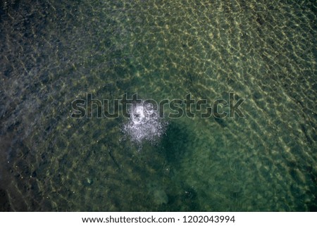 marks in a canadian river after throwing a stone