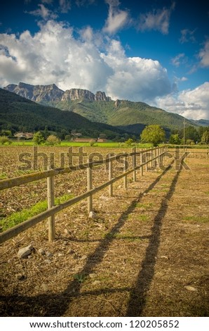 Small wooden fence in field