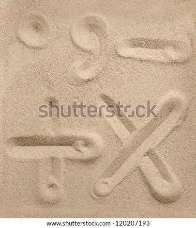 Punctuation and arithmetic signs writing on the sand