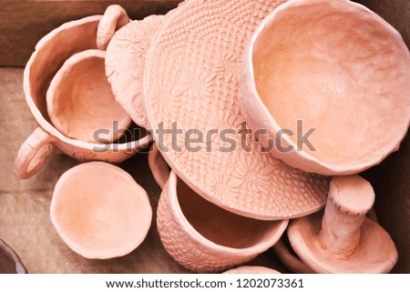 Handmade earthenware dries in the sun before firing. Handmade ceramics. Pottery