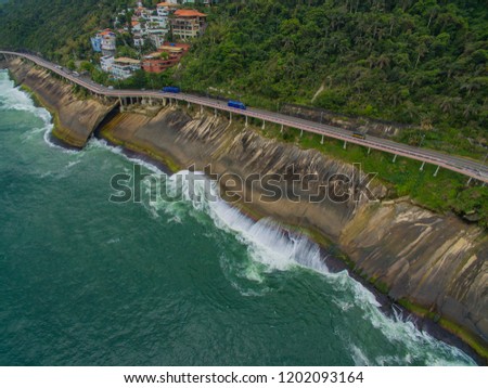 Highway by the sea and bike path. Asphalt road beside the sea, car advertising background.