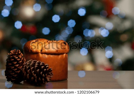 Panettone with Christmas lights in blurred background, Christmas image.