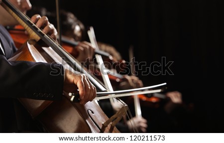 Symphony concert, a man playing the cello, hand close up Royalty-Free Stock Photo #120211573