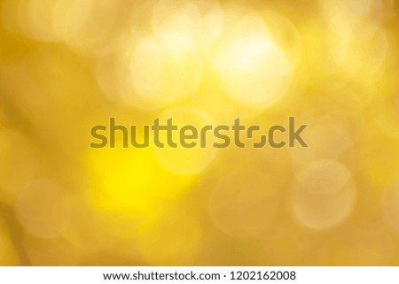 Abstract Gold Bokeh with soft blurred background nature blurry light party in vintage style warm pastel shimmering and faded cool colorful defocused circular. Shiny copy space for holiday card. 