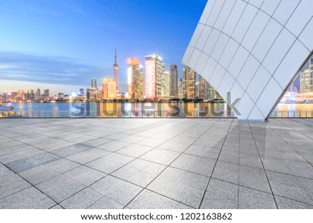 Empty floor and modern city buildings in Shanghai at night