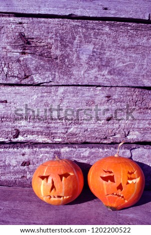 Halloween pumpkins  on old wooden surface gray vertical wall background