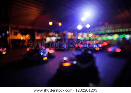 Blurred motion of people driving bumper cars