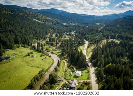 Beautiful aerial drone photo of small highland town in Carpathian mountains surrounded with forest and green hills.Popular travel destination for active tourism in Southern Europe.