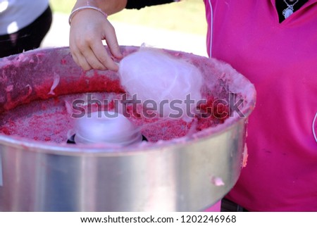 Making Pink fairy floss at local community festival 