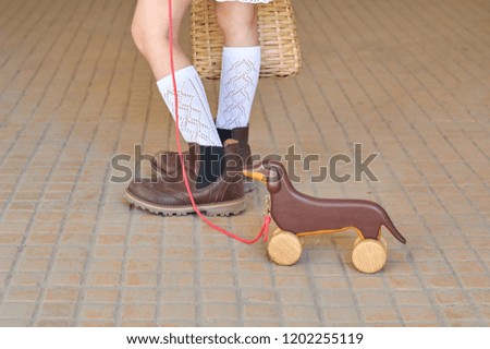 Kids playing with wooden dog background 