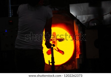 Glass Artist puts the glass in the oven to make it malleable.