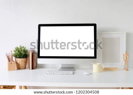 Office desk with mockup computer on stylish table.