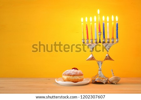 image of jewish holiday Hanukkah background with traditional menorah (traditional candelabra) and burning candles