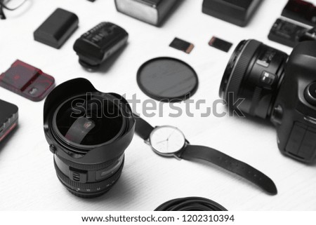 Composition with equipment for professional photographer on wooden background