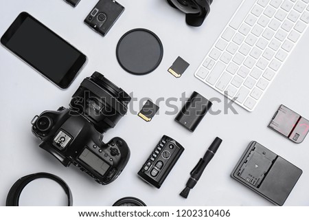 Flat lay composition with equipment for professional photographer on white background