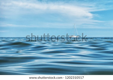 Picture of small boat in an open sea with texture like water