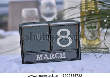 Wood blocks in box with date, day and month 8 March. Wooden blocks calendar