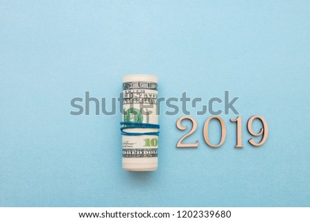 dollar money into the pipe and wooden figures 2019, the new year will be richer.