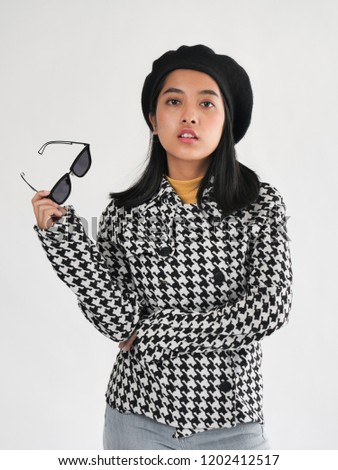 Portrait of Asian woman wearing winter jacket and sunglasses, winter lifestyle fashion.