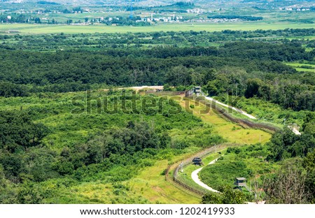 A border fence between two Koreas located in DMZ.  Royalty-Free Stock Photo #1202419933