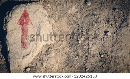 Red arrow on stone close-up