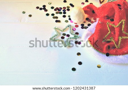 Christmas party background, Santa Claus hat and sparkling confetti, space for text or signs.