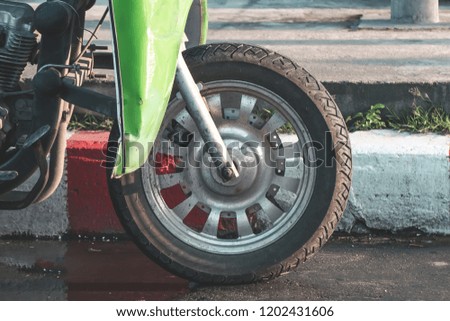 Car tires,The front wheels of a car parked on the lot used for travel adventures,Wheels are capable of sticking to the road surface as well.Bigfoot truck.