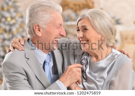 Portrait of elderly couple ear christmas tree