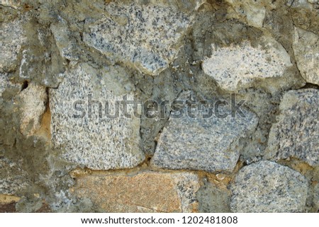 Wall of stones and cement. Close-up. Background. Texture.