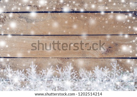 Wooden brown christmas background and snow white with snowflakes, copy space.