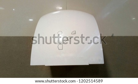 Air hand dryer in toilet at Department in Thailand.