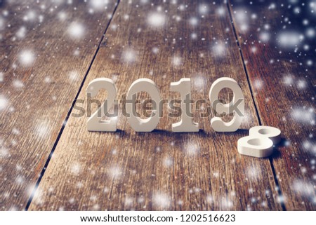 Wooden numbers forming the number 2019, For the new year 2019 on rustic wooden with snow cold.