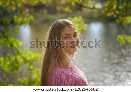 portrait of a young European girl in an autumn Park with yellow foliage