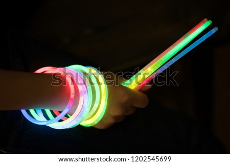 glow sticks with hand Royalty-Free Stock Photo #1202545699