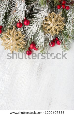 Fir branch with Christmas decorations on old wooden shabby background with copy space for text. Top view.