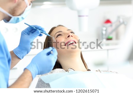 Happy woman with perfect smile in a dentist office ready to treatment Royalty-Free Stock Photo #1202615071