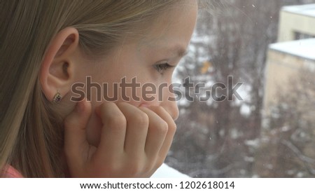Sad Child Looking on Window, Unhappy Thoughtful Kid, Girl Face, Snowing Winter