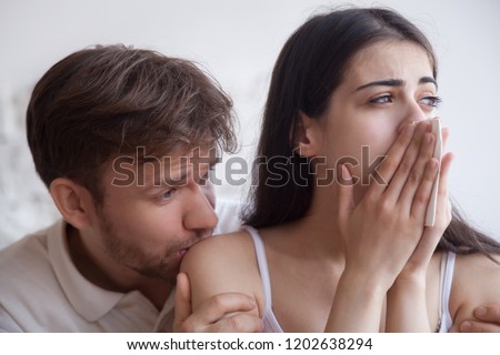 Loving man soothing crying woman with handkerchief in hands, apologizing after quarrel, interruption unwanted pregnancy, miscarriage, boyfriend kiss girlfriend shoulder, hug support, break up close up Royalty-Free Stock Photo #1202638294