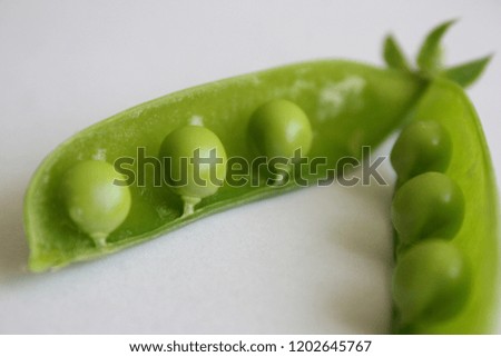 Fresh green pea (Pisum sativum) in pods on white background