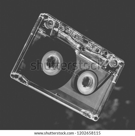 Audio cassette levitation. Retro media technology from the 80s. Mystical light.