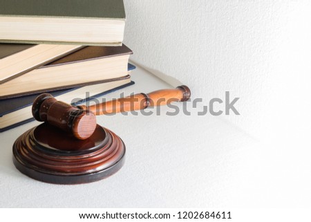 hammer judge on the background of a pile of books, the image on a light background.