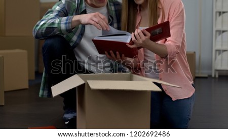 Couple in love moving in together, happy family unpacking boxes in new apartment