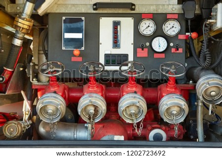 Control panel and faucets on the back of a fire truck