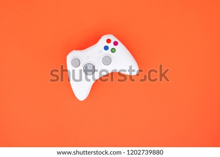 Gamepad is isolated on a red background. Gaming competition. White joystick on red background. Gamer concept. Controller for video games.