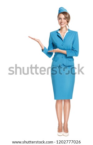 Portrait of charming stewardess wearing in blue uniform. Isolated on white background. Royalty-Free Stock Photo #1202777026