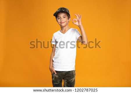 Happy young boy over yellow background