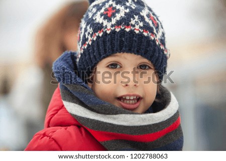 child learning to skate on ice