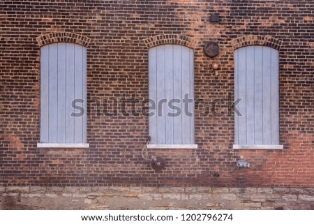 Forgotten brick building with boarded up windows
