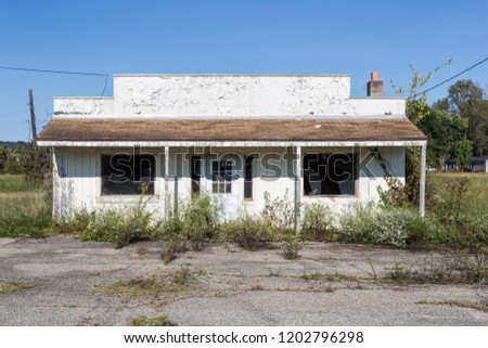 Abandoned building on roadside with a clear sky