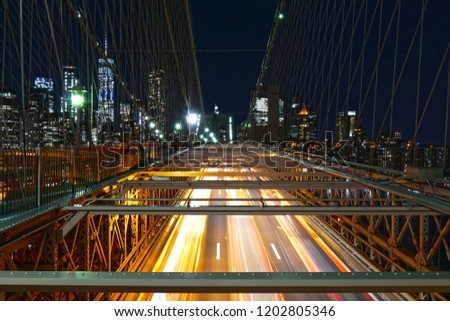 New York City skyline, traffic at the Brooklyn Bridge at night, Manhattan buildings and skyscrapers